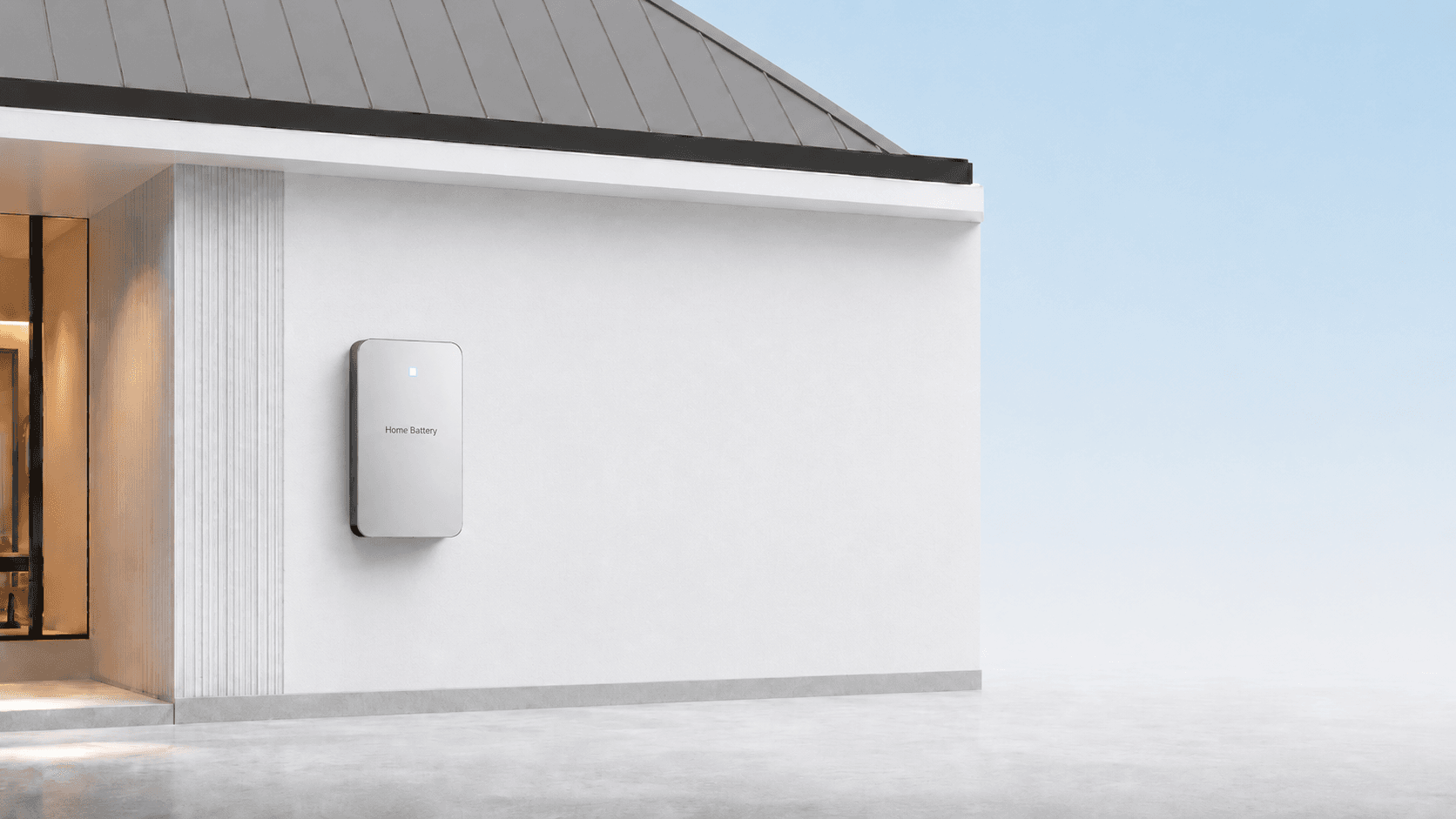 A home battery mounted on the exterior wall of a modern white house